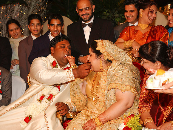 Bride being fed by Groom