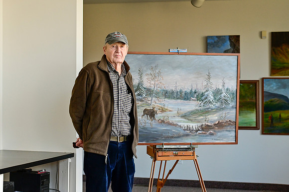 Odd Andersen (Standing with his painting on the stand)